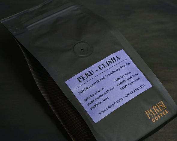 Parisi Peru Geisha honey processed coffee beans in black reserve packaging with floral and citrus tasting notes